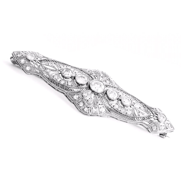 designed as a geometrically structured plaque around three old mine European-cut diamonds.Approximately 3 inches long and set with approximately 25 carats of baguette and brilliant-cut diamonds.
